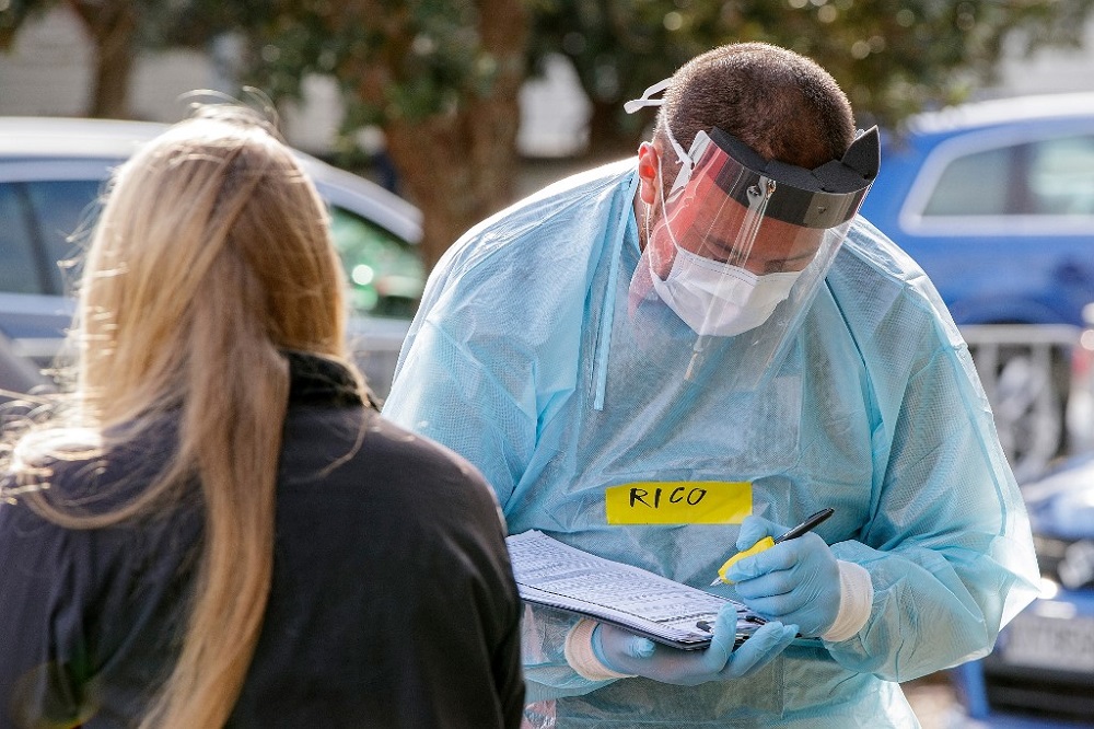 A health worker takes details at a COVID-19 testing station setup at Eden Park, National Sports Stadium, in Auckland August 14, 2020. u00e2u20acu201d AFP pic