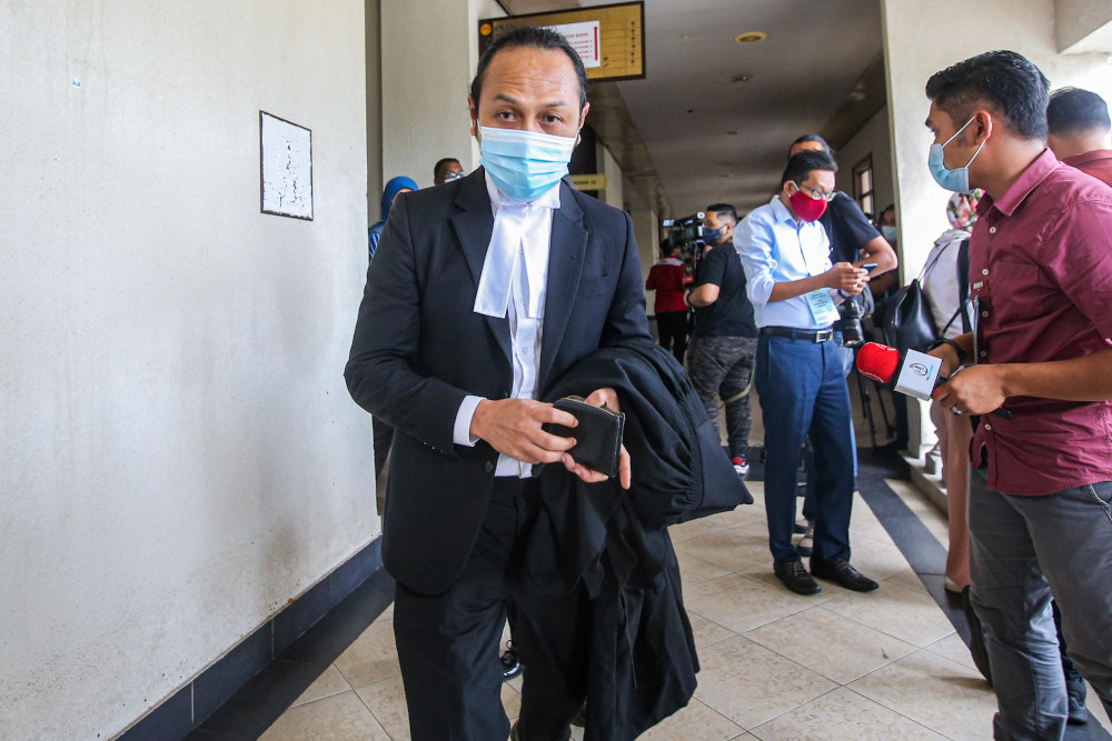 Lawyer to the teenager Mohd Haijan Omar (centre) leaves courtroom on August 17, 2020 after the teen was sentenced to imprisonment over the death of 23 people in a fire at Pusat Tahfiz Darul Quran Ittifaqiyah. — Picture by Hari Anggara