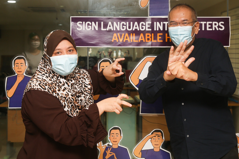 Malaysia Federation of the Deaf honorary secretary Eamiernor Zakiah Md Zuki (left) signs the word for u00e2u20acu02dcvirusu00e2u20acu2122 while executive director Mohamad Sazali Shau00e2u20acu2122ari makes the sign for u00e2u20acu02dcCovid-19.u00e2u20acu2122 u00e2u20acu201d Picture by Choo Choy May