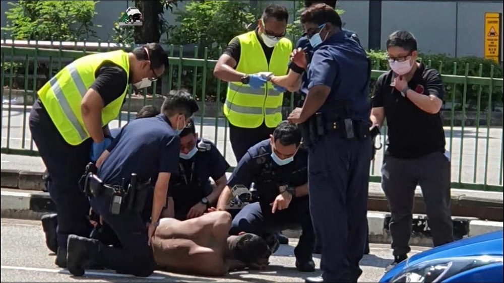 A man was arrested for disorderly behaviour, voluntarily causing hurt to public servants and alleged consumption of controlled drugs. He is also wanted for an outstanding warrant of arrest. u00e2u20acu201d Picture via Facebook/Singapore Road Accident