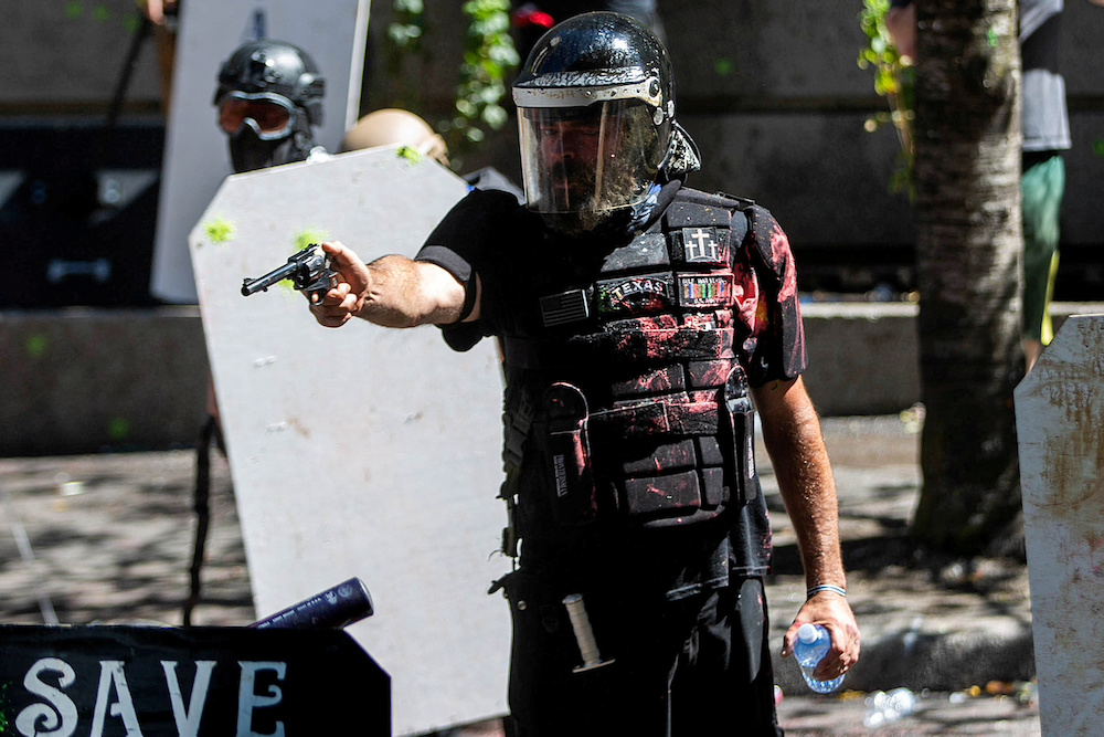 Alan Swinney points a gun during clashes between groups like Proud Boys and Patriot Prayer, and protesters in Portland, Oregon, August 22, 2020. u00e2u20acu201d Reuters pic