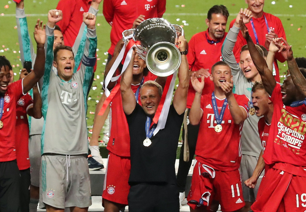 Bayern Munich coach Hansi Flick lifts the trophy as they celebrate winning the Champions League, Lisbon August 23, 2020. u00e2u20acu201d Miguel A. Lopes/Pool via Reuters