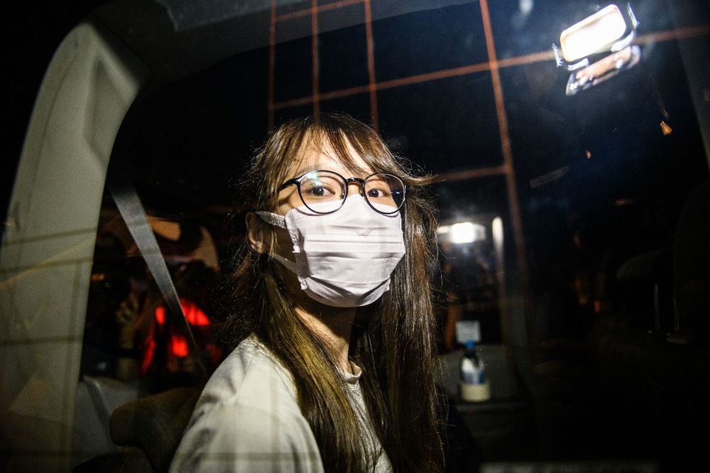 Prominent Hong Kong democracy activist Agnes Chow looks out of a car window while being driven away by police from her home after she was arrested under the new national security law in Hong Kong late on August 10, 2020. u00e2u20acu201d AFP pic