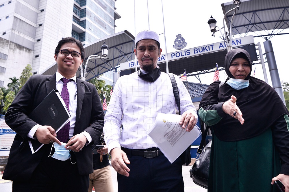 Hot Burger Malaysia founder Mohd Asri Hamid or Asri Janggut (centre) is seen outside the Bukit Aman police headquarters in Kuala Lumpur August 14, 2020. u00e2u20acu201d Bernama pic