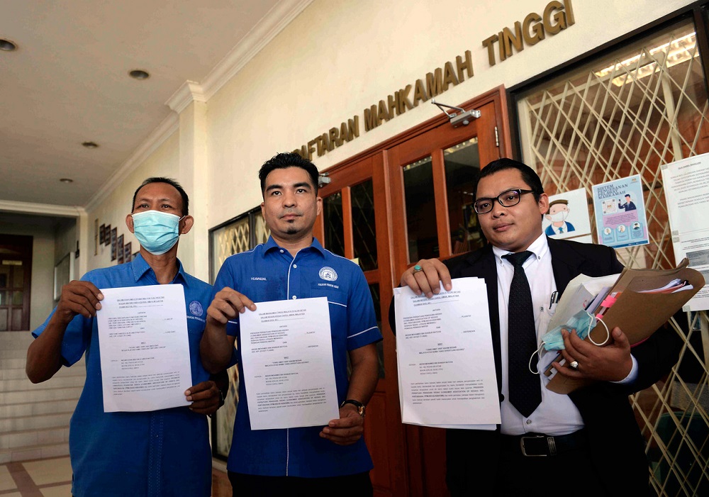 Consumers Association of Kedah secretary Mohamad Yusrizal Yusoff (centre) poses for a photo after filing a lawsuit against Nezar Mohamed Sabur Batcha, outside the High Court in Alor Setar August 19, 2020. u00e2u20acu201d Bernama pic