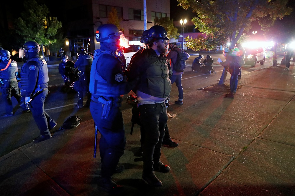 Police officers detain a demonstrator during a protest against police violence and racial injustice in Portland, Oregon August 24, 2020. u00e2u20acu2022 Reuters pic