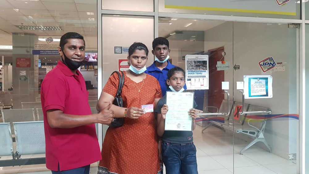 Karthiyani Ragunathan, 10, received her birth certificate and her MyKID on August 5, 2020. Seen here are her mother, her brother and activist Shanmugam Narayanasamy who assisted in their case. u00e2u20acu201d Picture courtesy of Shanmugam Narayanasamy