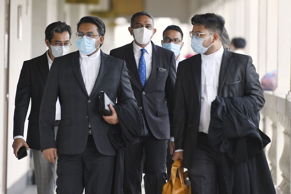 Lawyer Datuk Mohd Hafarizam Harun (centre) is pictured at the Kuala Lumpur High Court August 3, 2020. u00e2u20acu201d Picture by Ahmad Zamzahuri