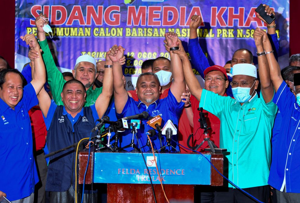 Barisan Nasional announces acting Tanjung Malim Umno chief Mohd Zaidi Aziz (centre) as its candidate for the Slim by-election during a press conference in Tanjung Malim August 12, 2020. u00e2u20acu201d Bernama pic