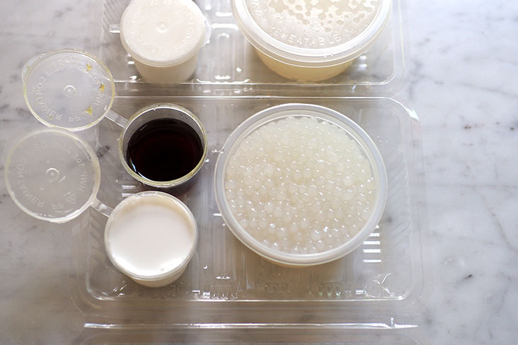 The sago puddings come in plastic containers that you can easily tip over to plate them with the fresh 'santan' and 'gula Melaka' syrup