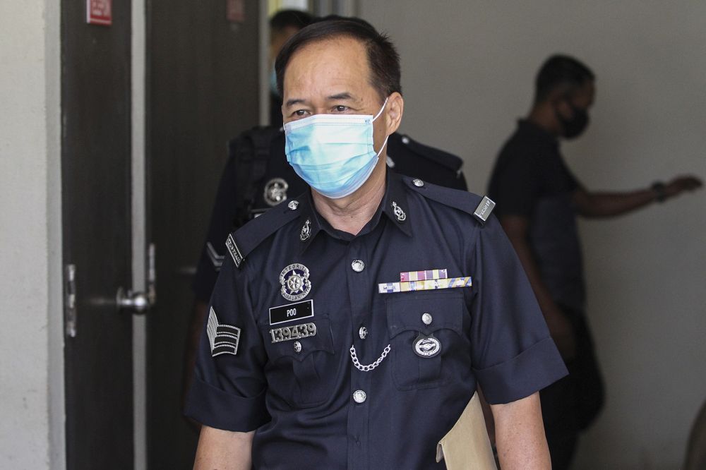 Negri Sembilan policeu00e2u20acu2122s K-9 unit handler Sergeant Poo Kong San is pictured at the Seremban Court Complex August 27,2020. u00e2u20acu201d Picture by Miera Zulyana