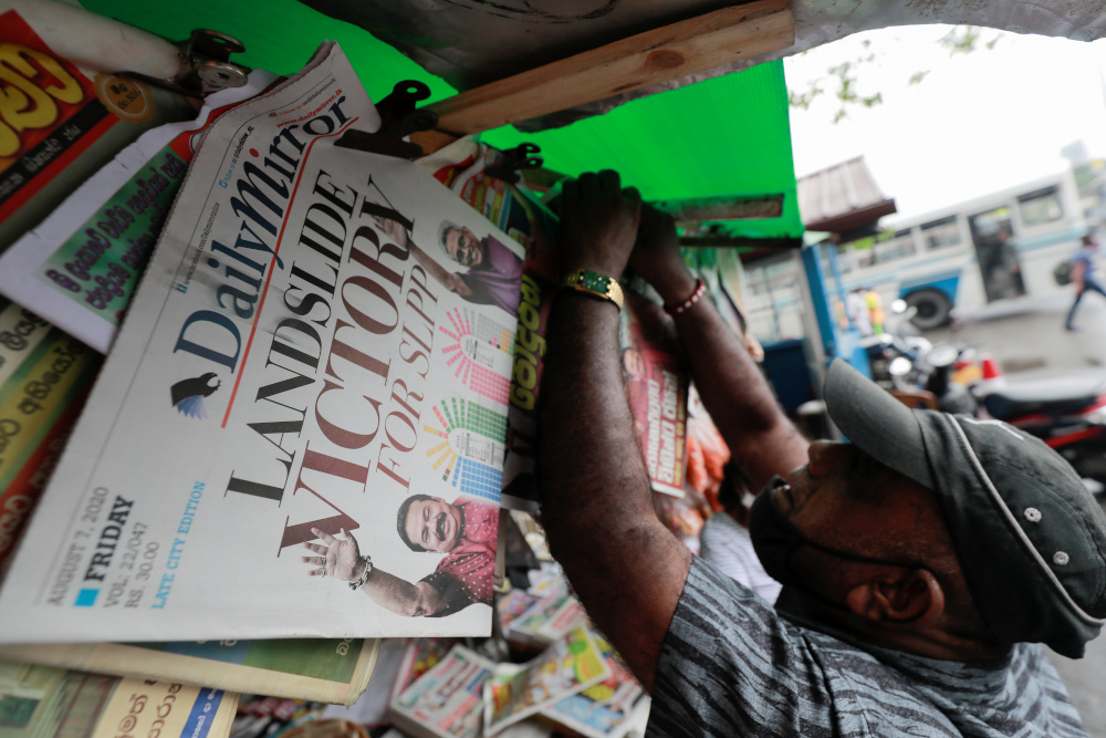 A man hangs newspapers carrying headlines about the victory of Mahinda Rajapaksau00e2u20acu2122s Sri Lanka Peopleu00e2u20acu2122s Front party in the countryu00e2u20acu2122s parliamentary election in Colombo, Sri Lanka, August 7, 2020. u00e2u20acu201d Reuters picnn
