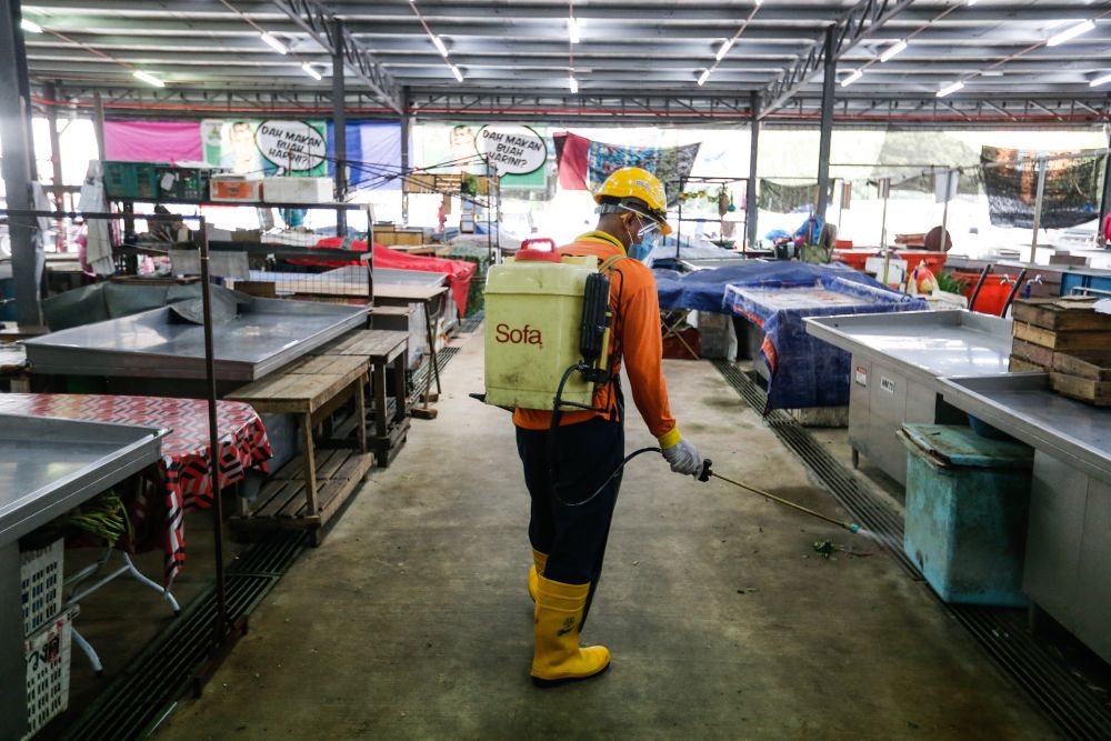 Seberang Perai Municiple Council personnel spray disinfectant at the temporary Seberang Jaya Wet Market on August 11, 2020. u00e2u20acu201d Picture by Sayuti Zainudin