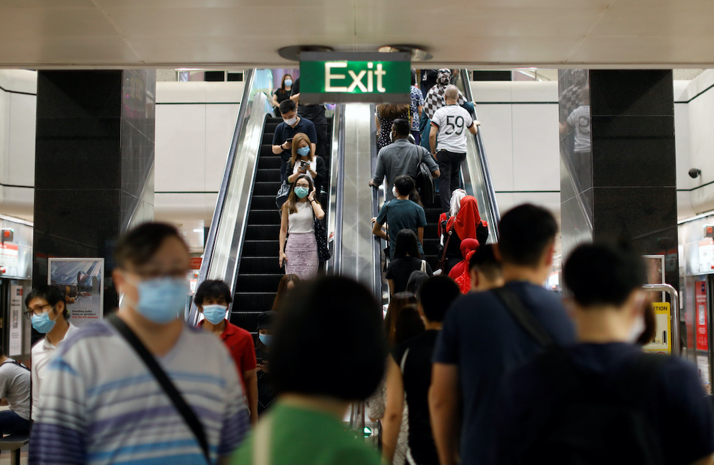 Commuters wearing protective face masks leave a train station during the coronavirus disease outbreak in Singapore August 17, 2020. u00e2u20acu201d Reuters picnnn