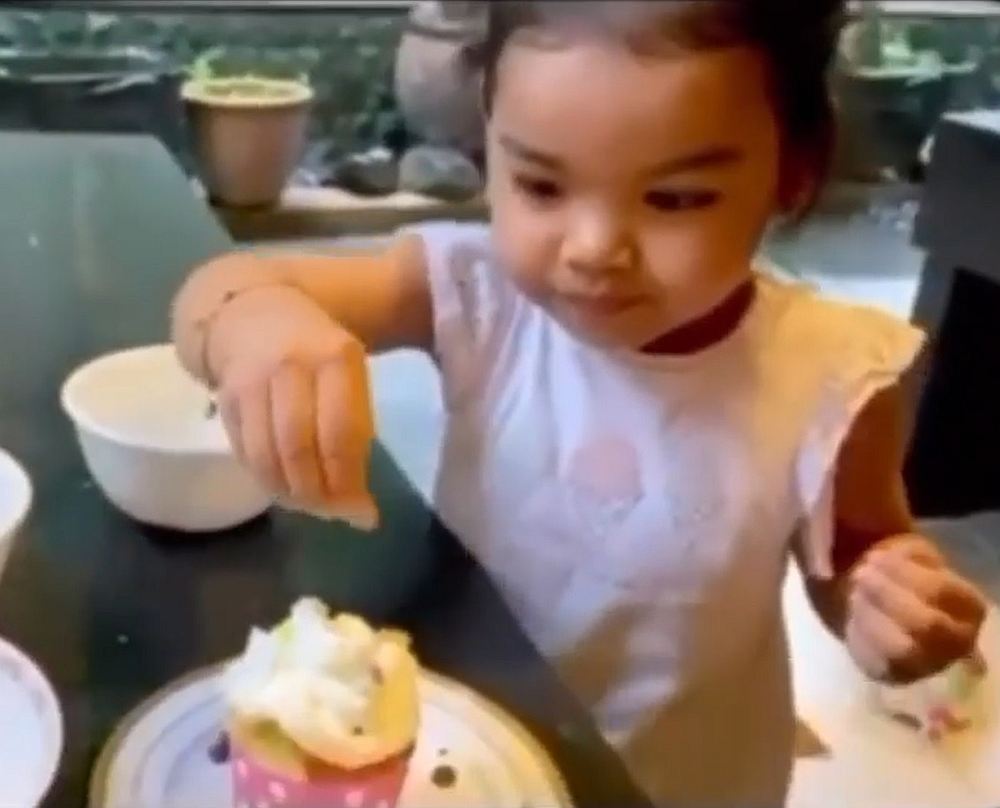 Aafiyah, 2, scatters sprinkles on cupcakes for her parents’ special day. — Screengrab from Instagram/Siti Nurhaliza