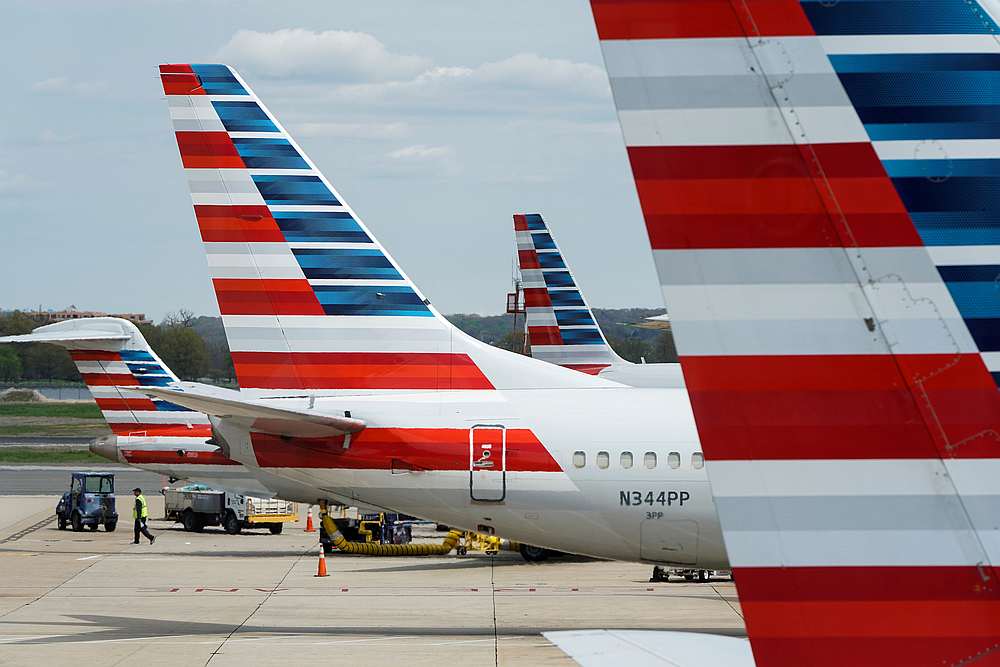 A member of a ground crew walks past American Airlines planes parked at the gate during the Covid-19 outbreak at Ronald Reagan National Airport in Washington April 5, 2020. u00e2u20acu201d Reuters pic