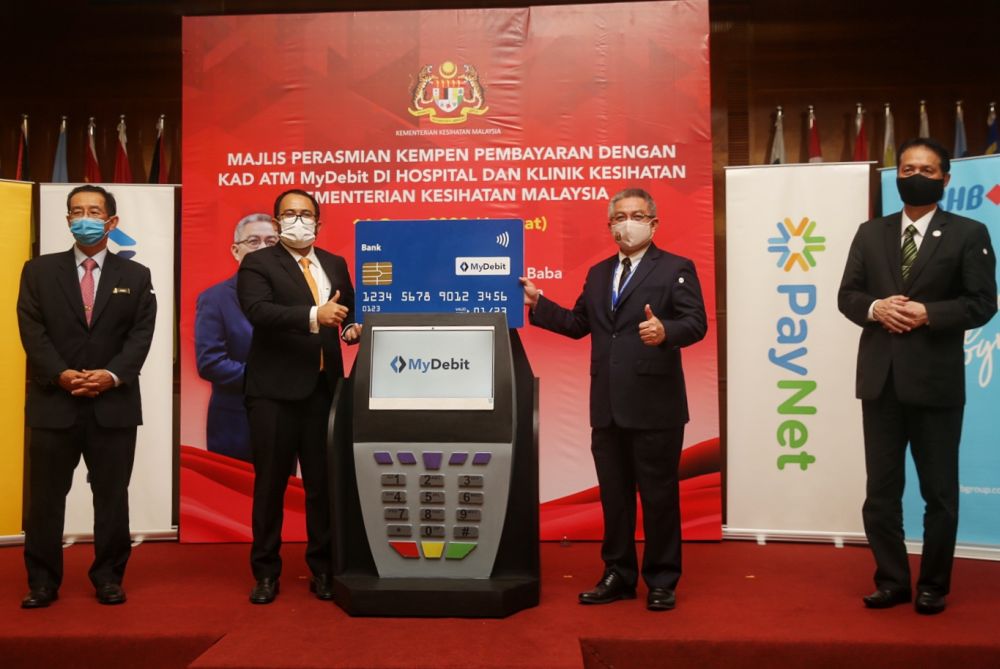 Datuk Seri Dr Adham Baba (second from right) attends a campaign on the use of MyDebit ATM cards at government hospitals and clinics in Putrajaya August 14, 2020. u00e2u20acu201d Picture by Choo Choy Maynn