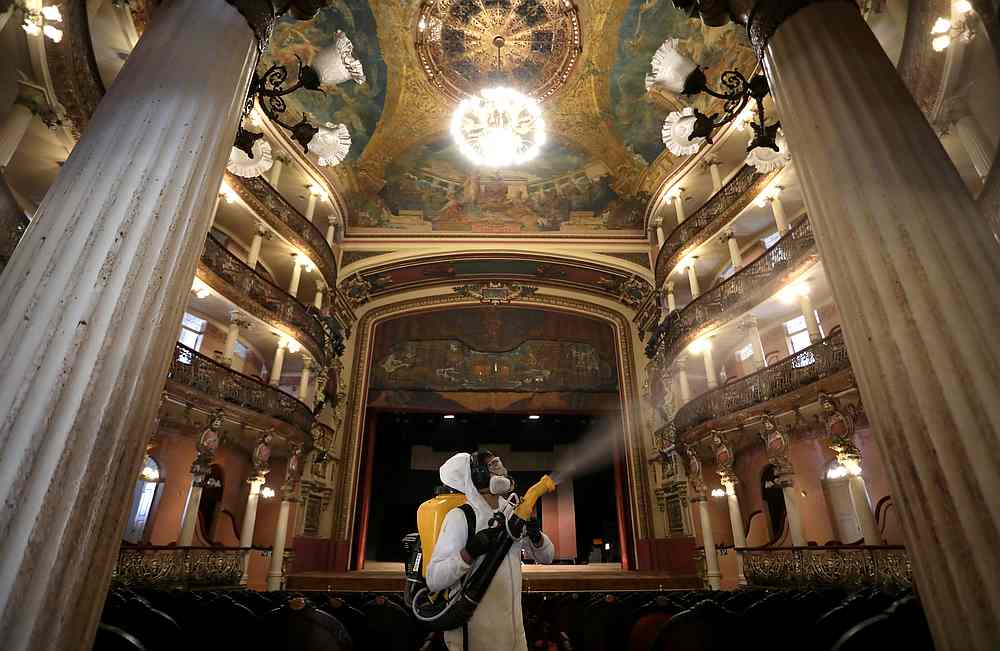 A worker in a protective suit sprays to disinfect the Amazonas Theatre ahead of its reopening after the Amazonas state government eased isolation measures,  in Manaus, Brazil August 2, 2020. u00e2u20acu201d Reuters pic