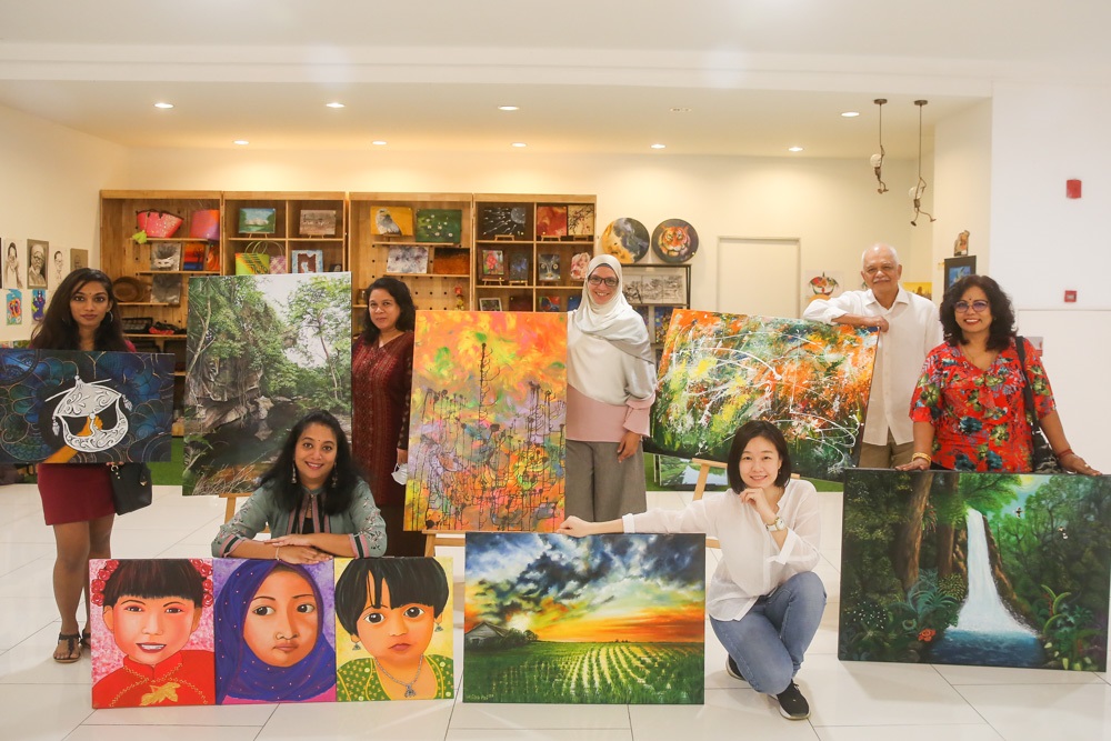 The artists and their artworks for the Merdeka Art Exhibition, from left, Anussha, Massalwa Jaffar, Khainifa Khalil, Professor Abdul Hamid Mohamed and Lalitha Pillay with Priya Yogi (bottom left) and (bottom right) Hsiao Pei Quek. u00e2u20acu2022 Picture by Choo Choy