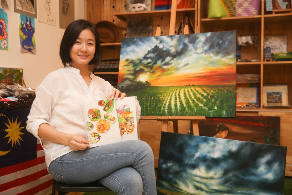 Part time Artist, Hsiao Pei Quek with some of her artworks that will be exhibited at the Merdeka Art Exhibition. 