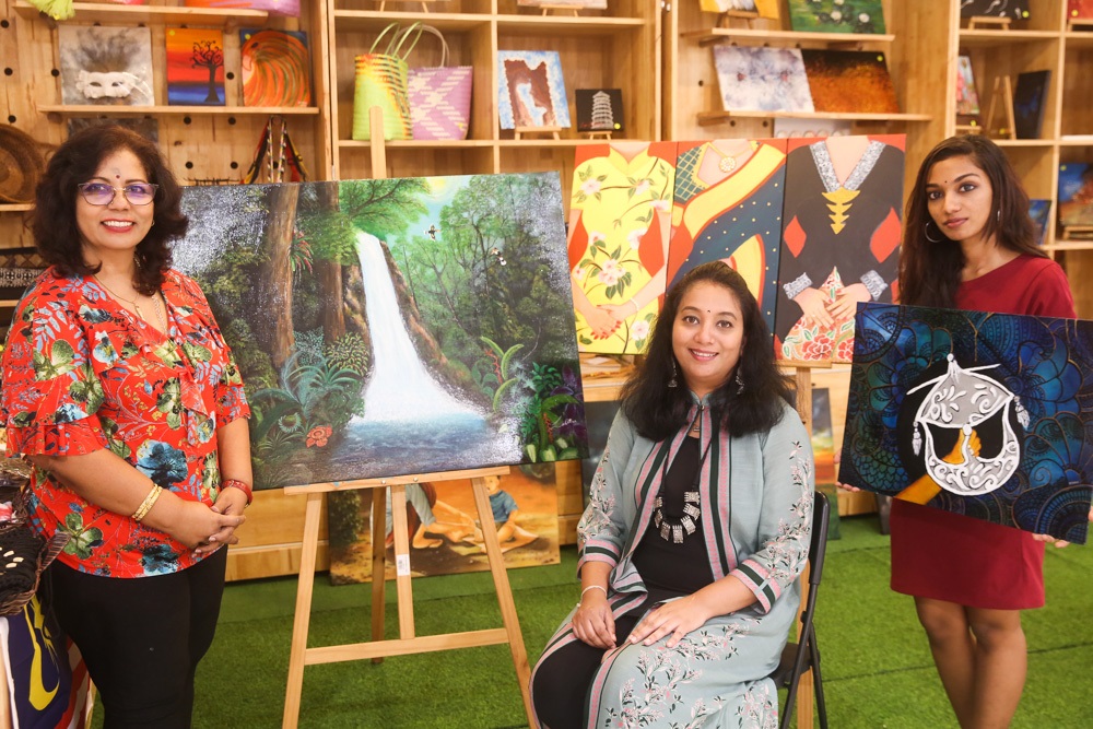 (From left) The '50 Shades of Sarawak Rainforest' painter Lalitha Pillay, middle the artist for 'The Common Thread' painting, Priya Yogi and right, the artist for 'The Tranquil Wau', Anussha. 