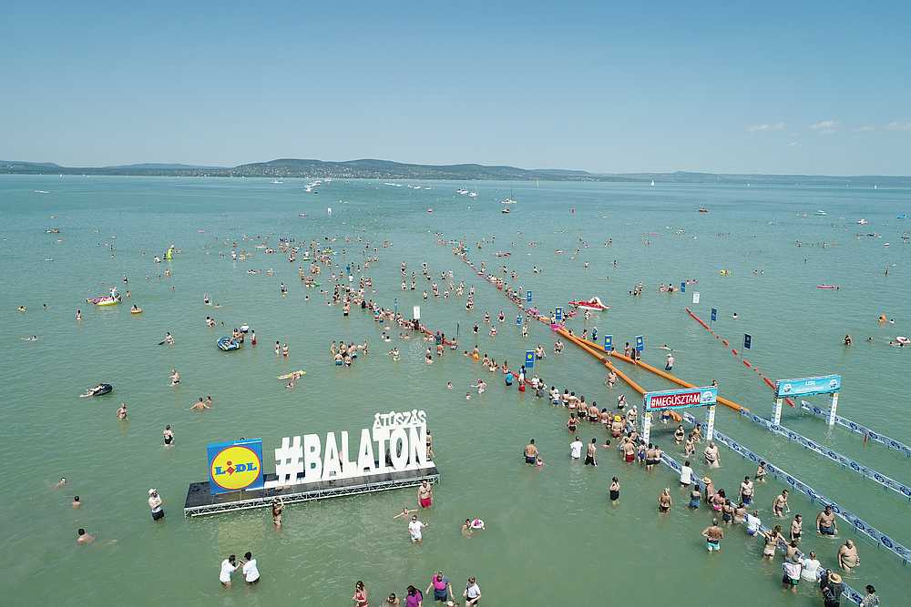 Participants of the 38th Lidl Balaton Cross Swimming arrive at the finish line in Balatonboglar, Hungary, August 1, 2020. u00e2u20acu201d Balaton-atuszas drone pic handout via Reuters