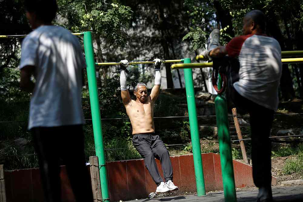 A man exercises at a park, after Beijing Centre for Disease Prevention and Control announced face masks are no longer mandatory outdoor, following the Covid-19 outbreak, China August 21, 2020. u00e2u20acu201d Reuters pic