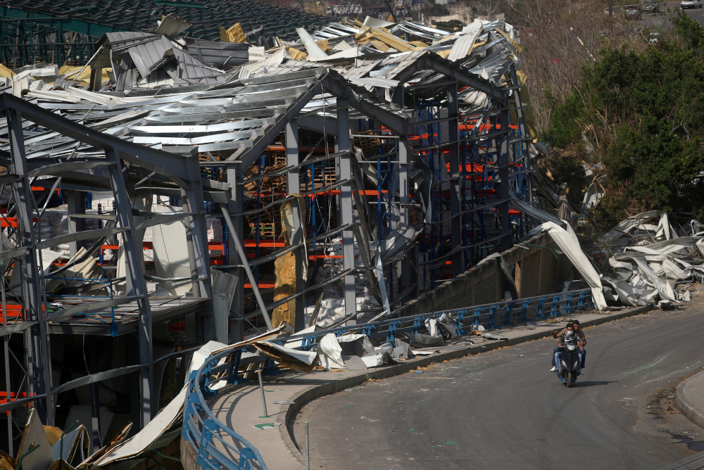 Men ride a motorcycle past the damage near the site of Tuesdayu00e2u20acu2122s blast in Beirutu00e2u20acu2122s port area, Lebanon August 7, 2020. u00e2u20acu201d Reuters pic 