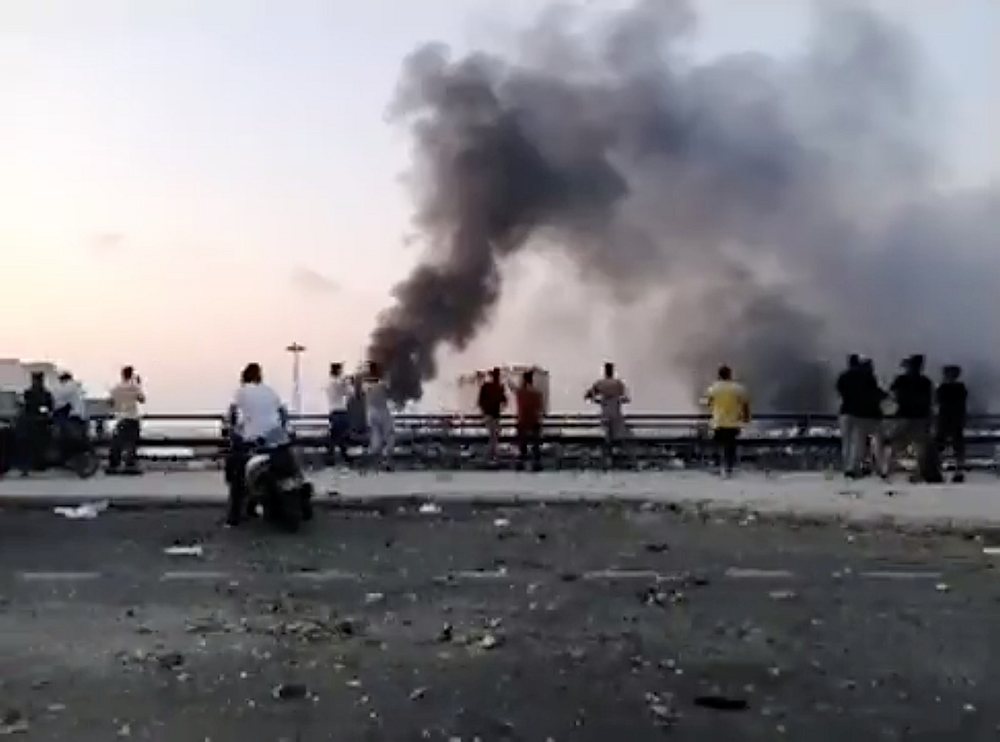 People observe the rising smoke after an explosion in Beirut, Lebanon August 4, 2020. u00e2u20acu201d We Love Lebanon/social media video image via Reuters