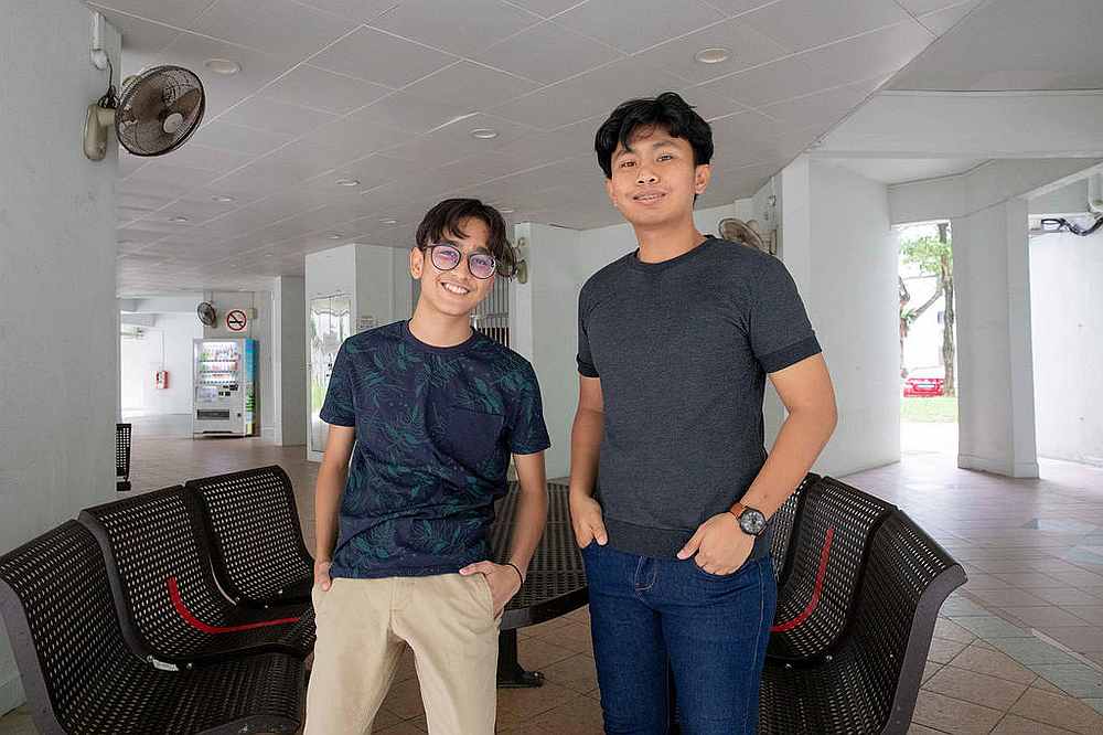 The two brothers, Muhammad Aniq Hilman Mohd Talib (left) and Norizam Baharon, at the void deck of Block 270 at Tampines Street 21, Singapore August 26, 2020. u00e2u20acu201d TODAY pic