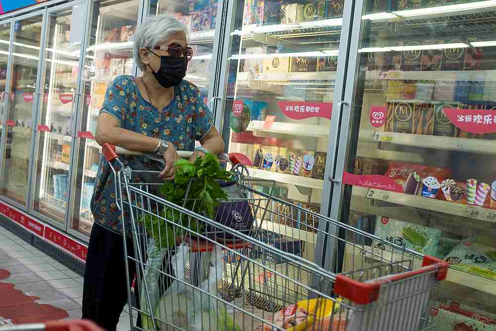 A woman looks at frozen food products in a supermarket following an outbreak of Covid-19 in Beijing, China August 13, 2020. u00e2u20acu201d Reuters pic