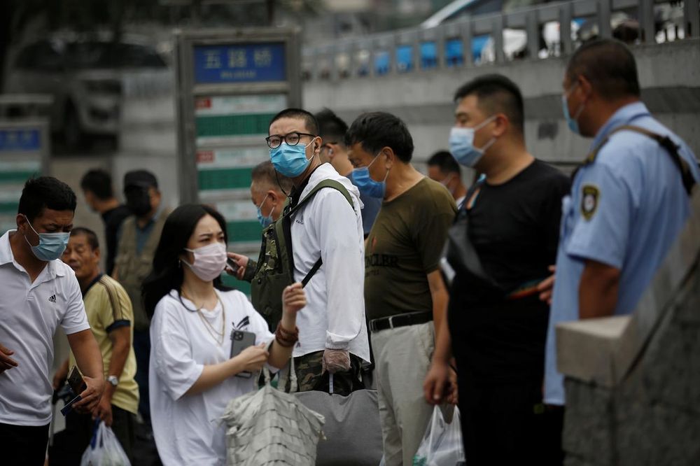 People wearing face masks wait at a bus stop during morning rush hour, following the outbreak of the coronavirus disease (Covid-19), in Beijing, China July 13, 2020. u00e2u20acu201d Reuters pic