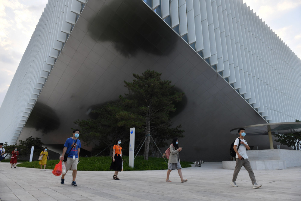 Staff walk out from the headquarters building of Tencent, the parent company of Chinese social media giant WeChat, in Beijing August 7, 2020. u00e2u20acu201d AFP picn