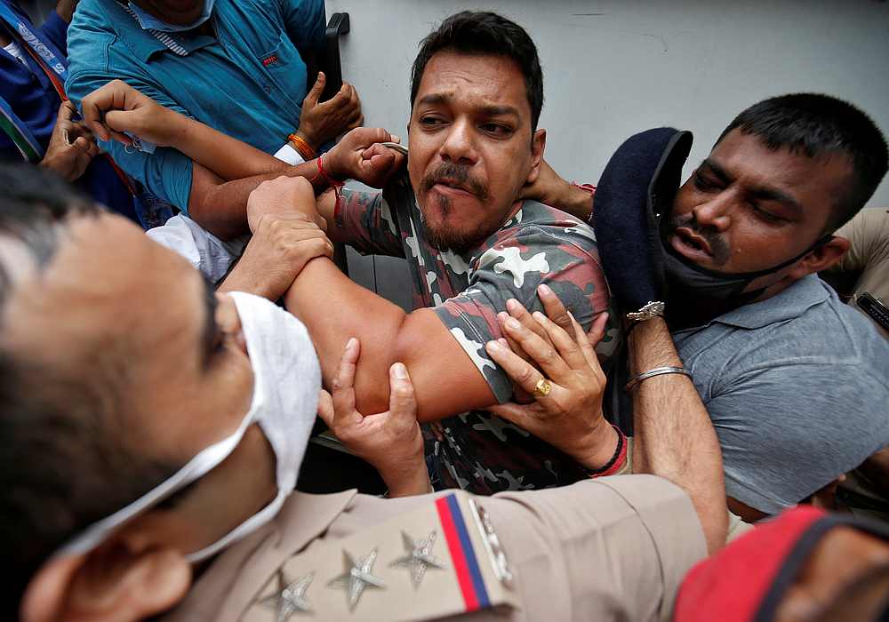 A Congress party activist is detained by police during a protest demanding postponement of admission tests to medical and engineering schools amid the spread of Covid-19, in Ahmedabad, India August 28, 2020. u00e2u20acu201d Reuters pic