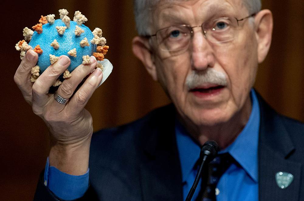Dr Francis Collins, director of the National Institutes of Health (NIH), holds up a model of the SARS-CoV-2 virus, during a US Senate hearing in Washington, July 2, 2020. u00e2u20acu201d Pool pic via Reuters