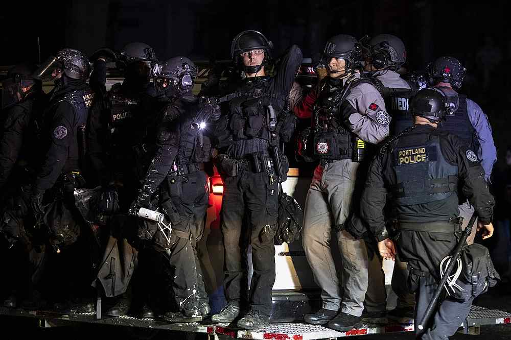 Portland police are seen in riot gear during a standoff with protesters in Portland, Oregon on August 16, 2020. u00e2u20acu201d AFP pic