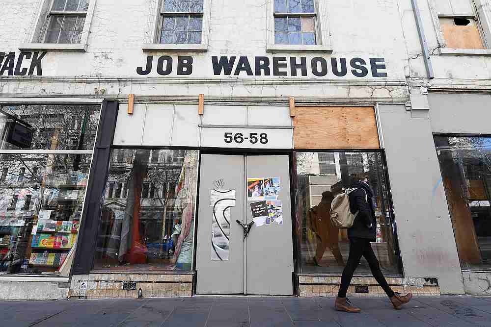 A pedestrian walks past a closed shop under lockdown restrictions to curb the spread of the Covid-19 in Melbourne, Australia, August 5, 2020. u00e2u20acu201d AAP Image via Reuters 