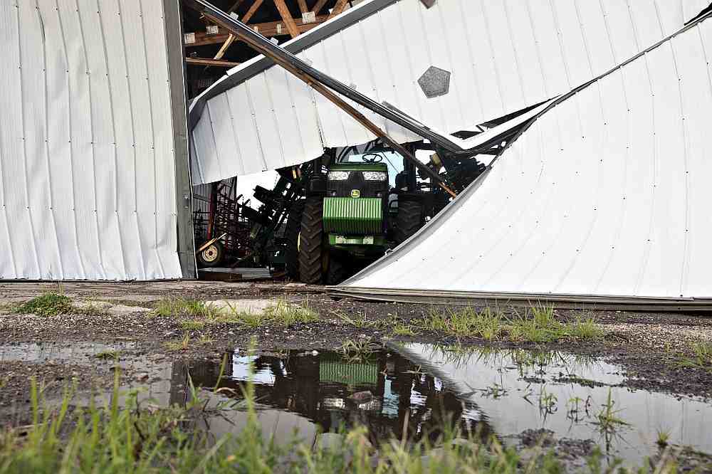 A John Deere agricultural tractor sits under a collapsed building following a derecho storm, a wind storm associated with rapidly moving showers or thunderstorms, near Franklin Grove, Illinois August 10, 2020. u00e2u20acu201d AFP pic
