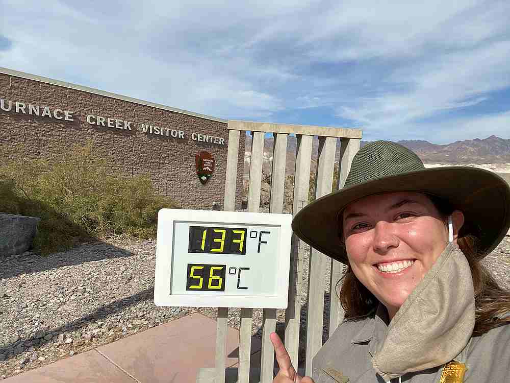 A Death Valley National Park employee next to a display showing the newly record breaking temperature in Death Valley National Park, California August 16, 2020. u00e2u20acu201d CAROLINE ROHE/social media pic via Reuters