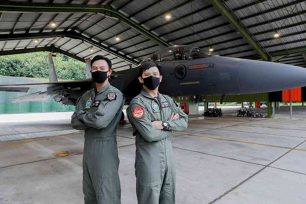 Captain Adam Eng Jun Chao (left) and Lieutenant Shidan Swah Yepeng with the F-15SG Fighter Aircraft at Paya Lebar Air Base July 23, 2020 as they prepare for the Singapore National Day flypast. u00e2u20acu201d TODAY pic 