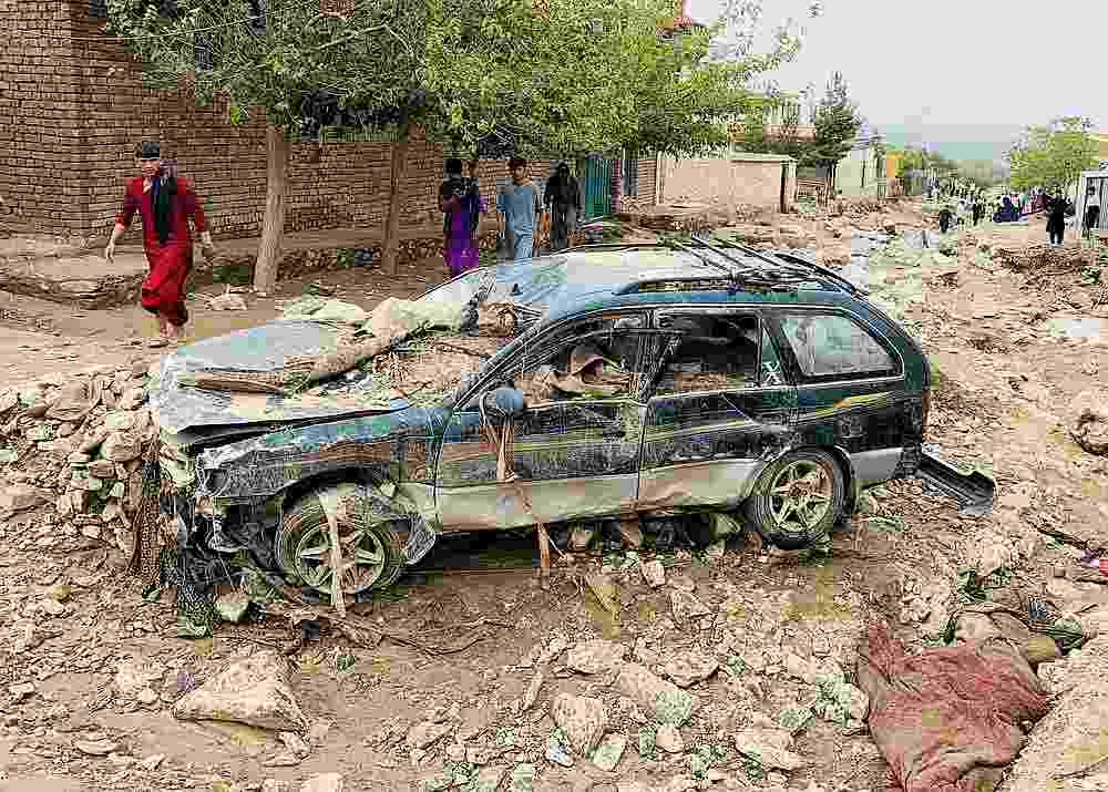 An Afghan man walks past a damaged vehicle after floods in Charikar, capital of Parwan province, Afghanistan August 26, 2020. u00e2u20acu201d Reuters pic