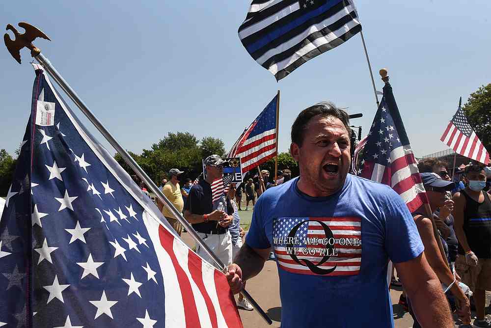A person wearing a T-shirt supportive of QAnon participates in a 'Back the Blue' rally in New York August 9, 2020. u00e2u20acu201d Reuters pic