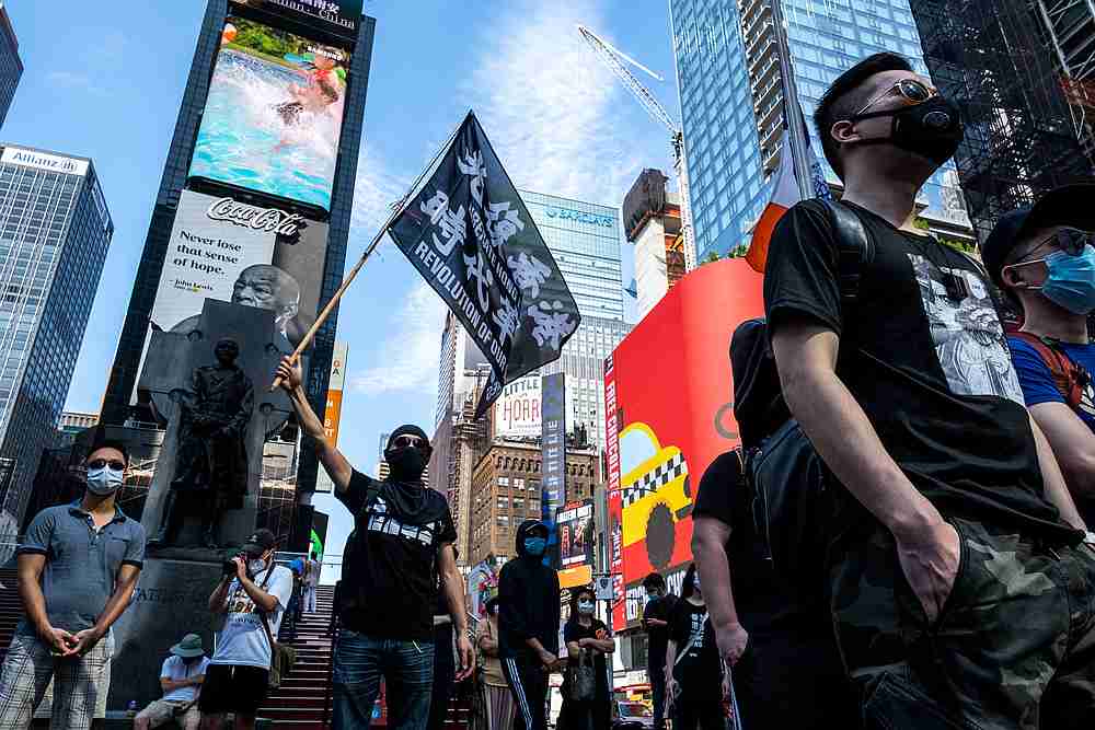 Protester supporting Hong Kong's pro-democracy movement wearing protective mask holds a flag as they attend the Delay No More, Democracy march in Times Square, New York August 2, 2020. u00e2u20acu201d Reuters pic