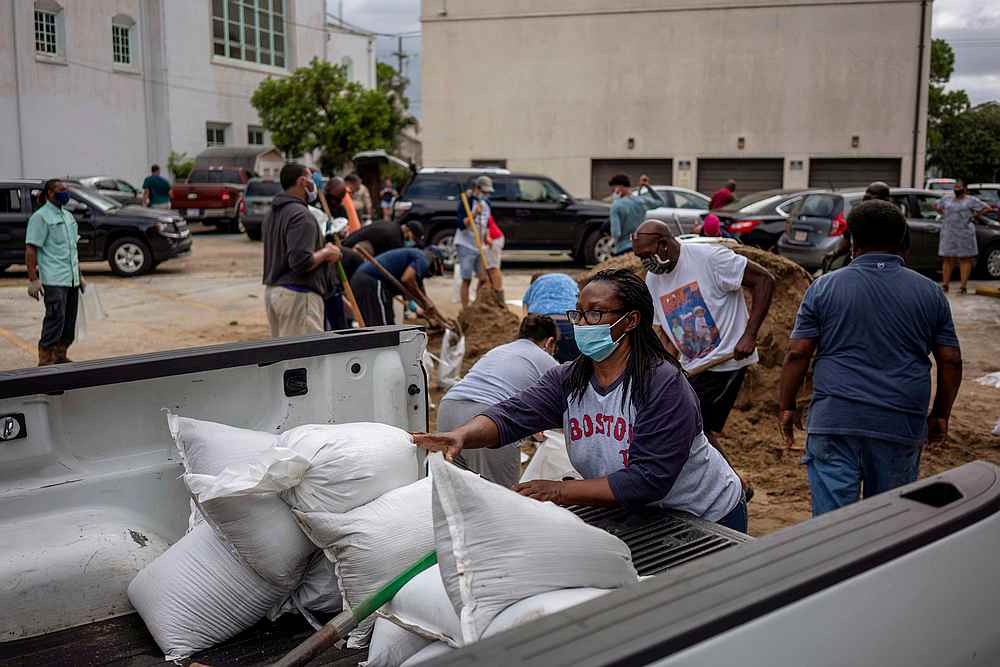 A woman puts sandbags on a cart as residents fill sandbags at St Raymond Churchas Hurricane Laura warnings have been issued for part of Louisiana and Texas, in New Orleans, Louisiana August 25, 2020. u00e2u20acu201d Reuters pic