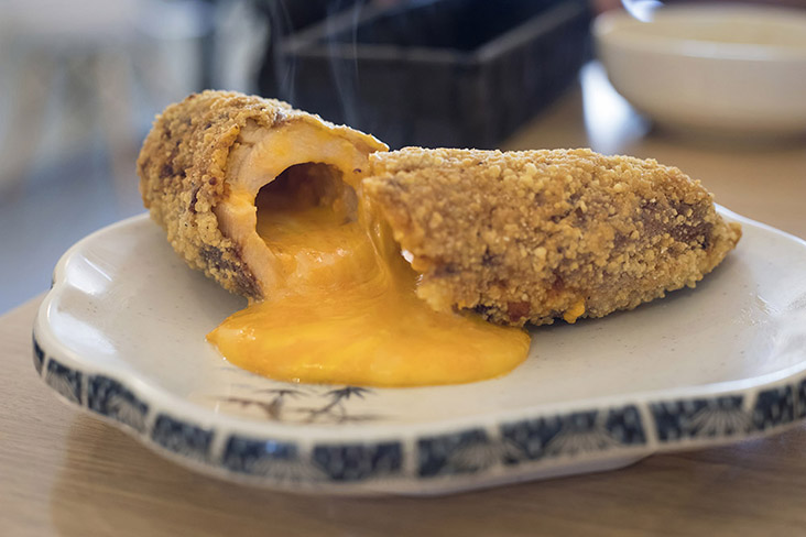 Slice into a breaded chicken roll and hot cheesy lava oozes out.