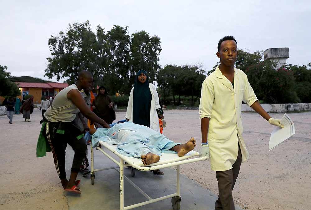 Paramedics and civilians carry an injured person on a stretcher at Madina hospital after a blast at the Elite Hotel in Lido beach in Mogadishu, Somalia August 16, 2020. u00e2u20acu201d Reuters pic