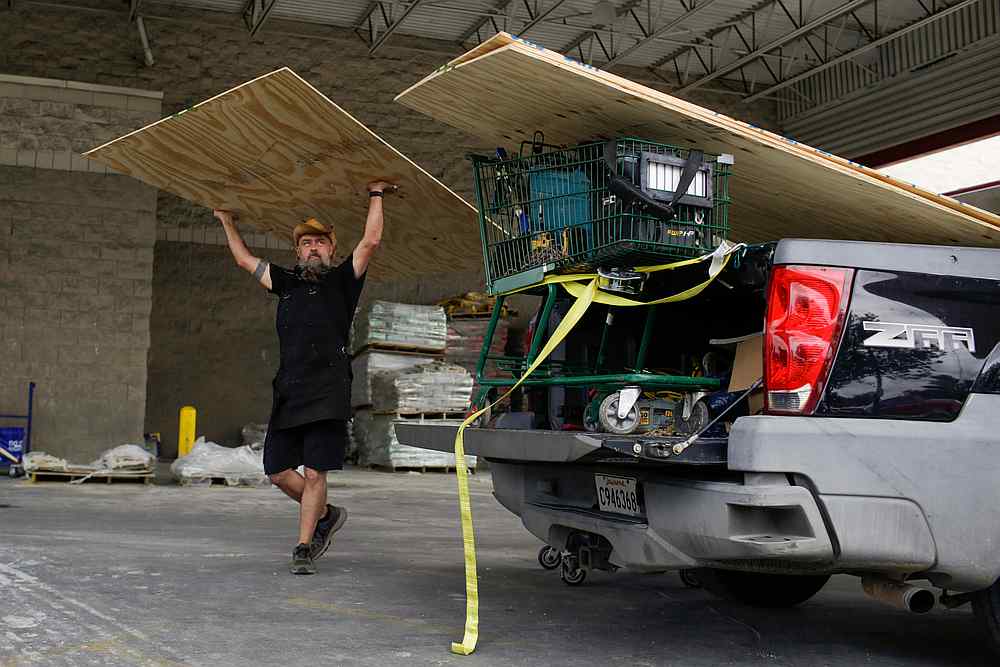Paul Humphrey, of New Orleans, loads plywood into his truck, to board a friend's home in preparation for the arrival of hurricanes Marco and Laura at Lowe's in New Orleans, Louisiana August 23, 2020. u00e2u20acu201d Reuters pic