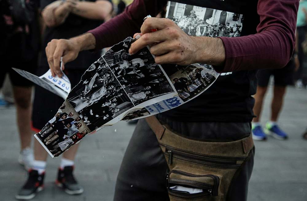 A protester destroys pictures of the royal family during a march against Spain's monarchy for the first time since former Spanish King Juan Carlos left the country, in Madrid, Spain August 9, 2020. u00e2u20acu201d Reuters pic