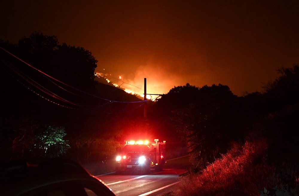 A fire truck drives on the road as the flames from the Lake Fire blaze down the hillside in the Angeles National Forest, by Lake Hughes, north of Los Angeles, California August 12, 2020. u00e2u20acu201d AFP pic
