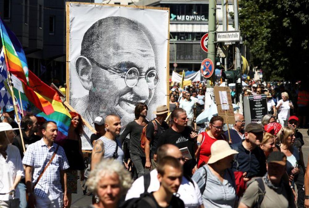 A portrait of Mahatma Gandhi is pictured as demonstrators march during a protest against the government's restrictions amid the coronavirus disease outbreak, in Berlin, Germany, August 1, 2020. u00e2u20acu201d Reuters pic